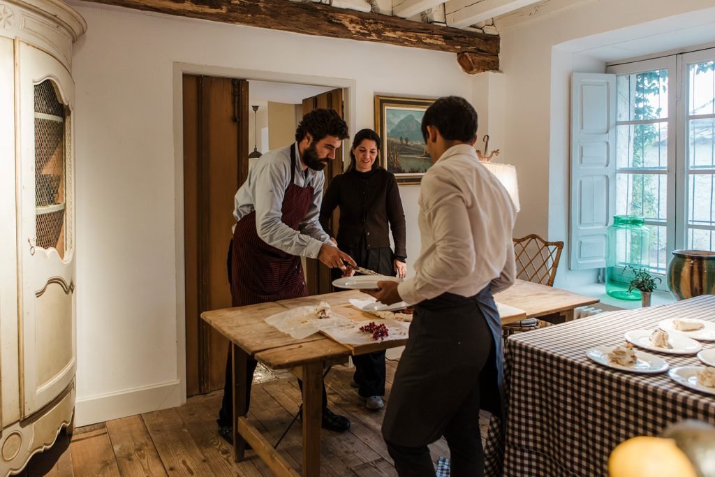 Outdoor destination wedding venue and catering details, featuring an outdoor fire setup and a berry pavlova cake. Destination wedding photographer Flor de Sal Photo.