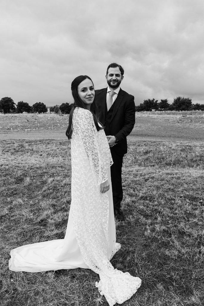 Natural and intimate wedding couple portraits outside a rustic chapel in the countryside. Timeless wedding photography by Flor de Sal Photo.