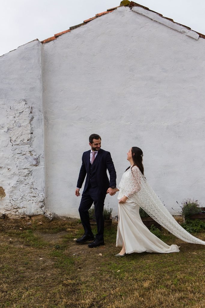 Natural and intimate wedding couple portraits outside a rustic chapel in the countryside. Timeless wedding photography by Flor de Sal Photo.