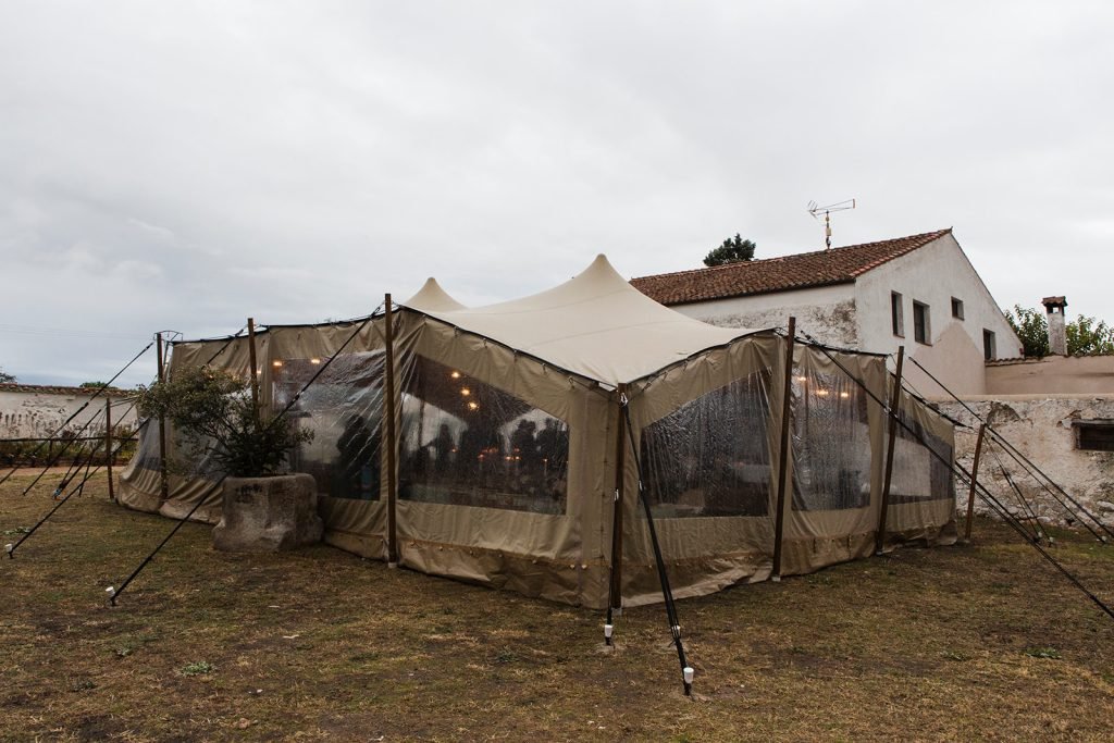 Elegant outdoor wedding reception tent setup at a historic countryside villa named Finca Aldeallana. Destination wedding photography by Flor de Sal Photo.