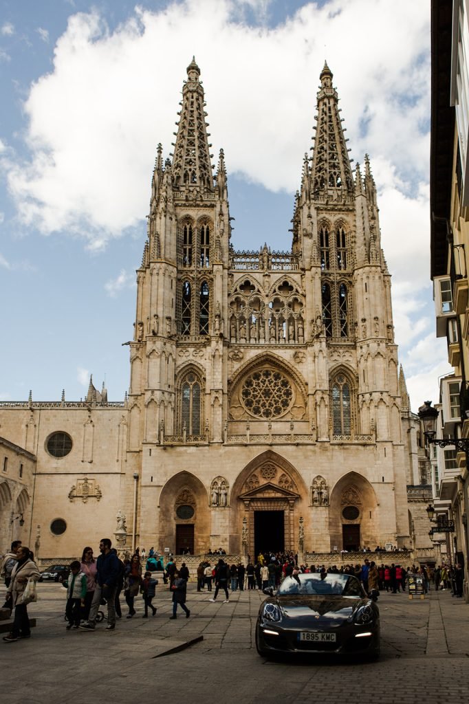 Destination wedding couple standing in front of a historic cathedral architecture. Destination documentary wedding photographer.
